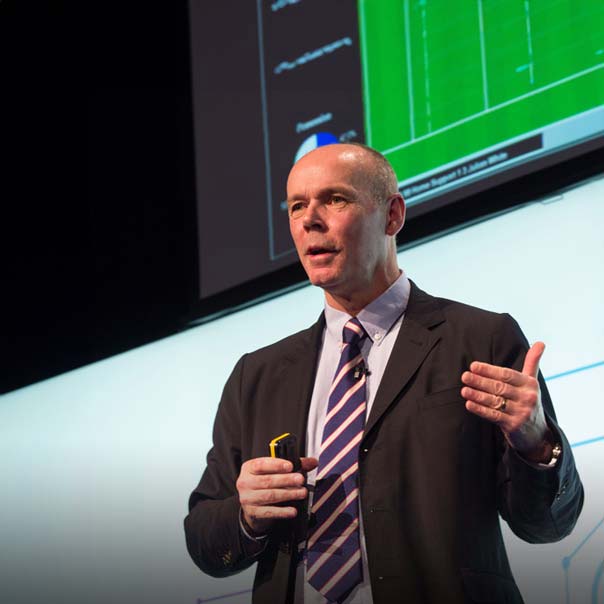 Clive Woodward speaking on stage.